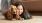 a person lying on the floor with a dog