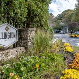Settle into comfort at Ellington Metro West a sign on a stone wall