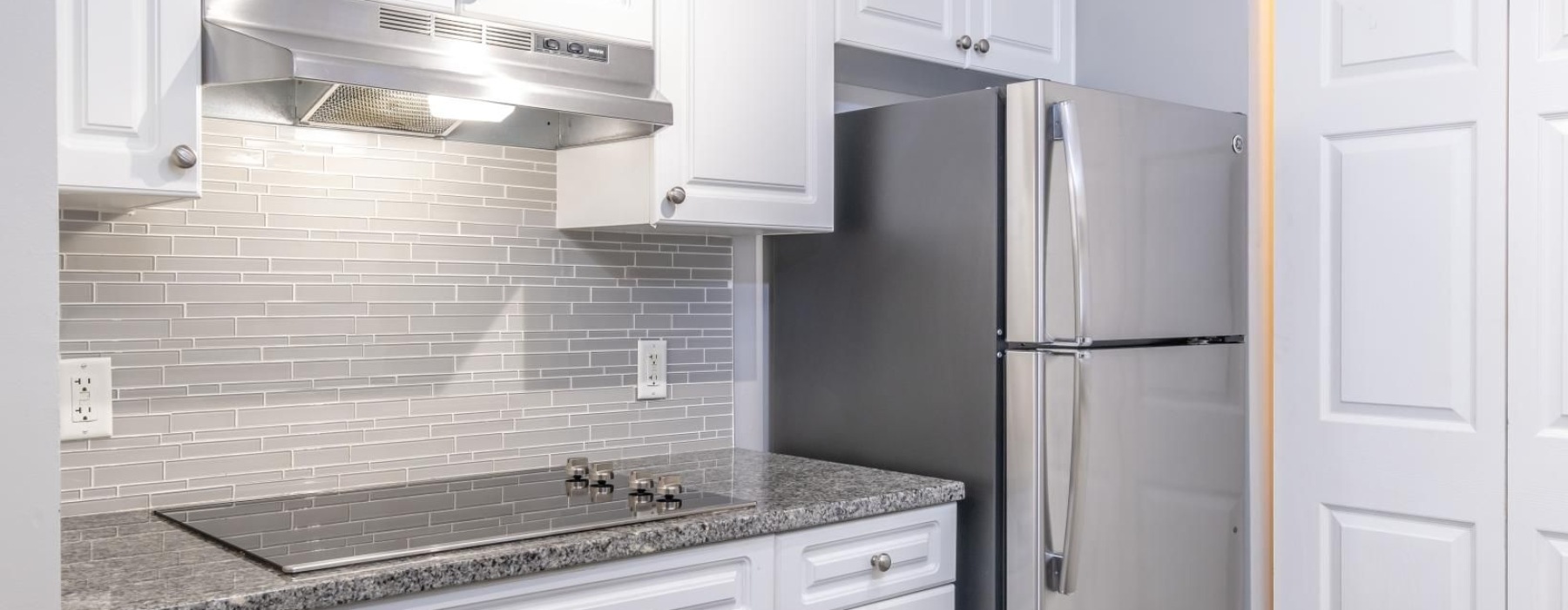 a kitchen with white cabinets