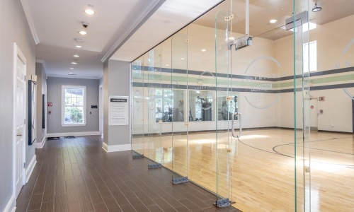a glass walled room with wood floors
