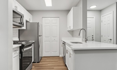 a kitchen with white cabinets
