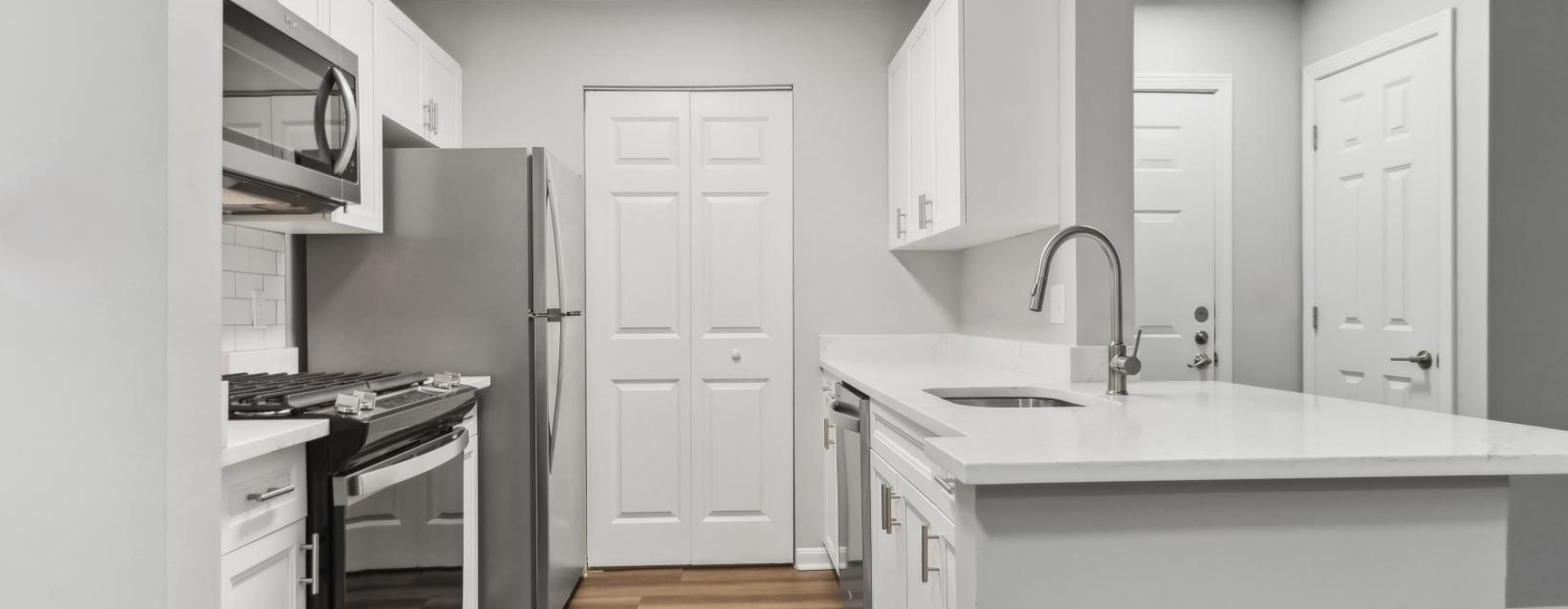 a kitchen with white cabinets